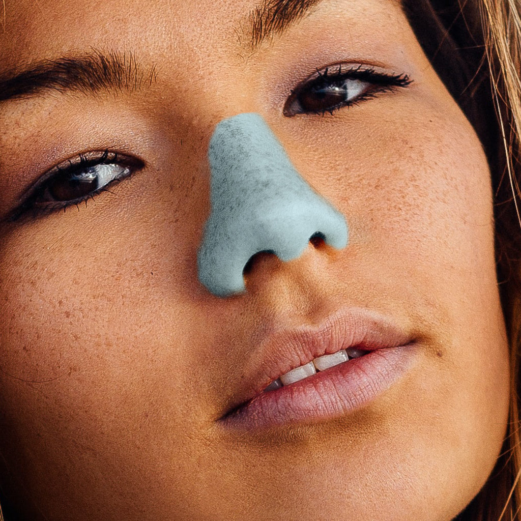 Up-close shot of woman wearing the Under the Sea shade of Noz reef safe, cruelty-free sunscreen.
